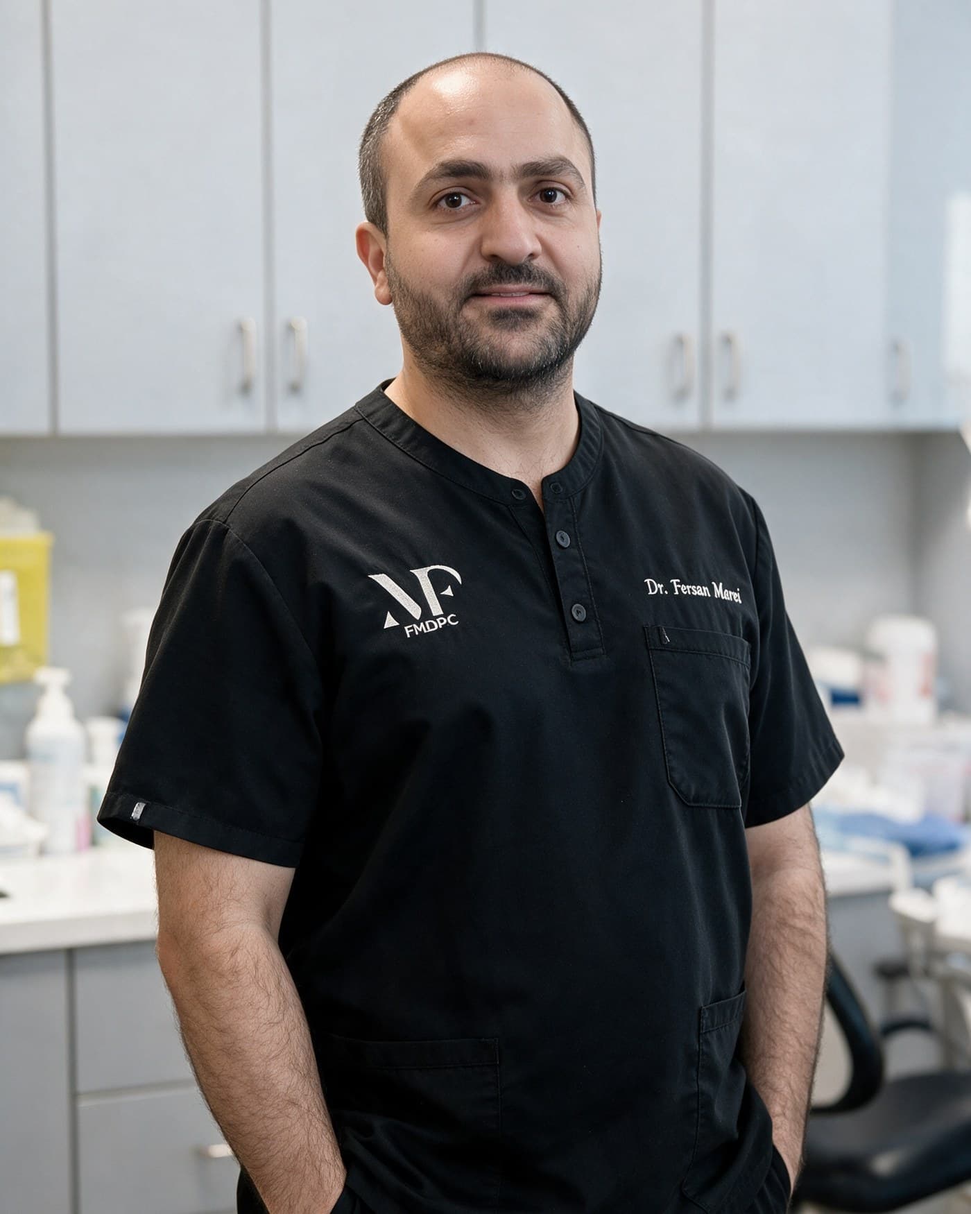 Dr. Fersan Marei in scrubs in a dental operatory